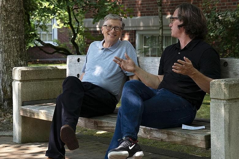 Mr Bill Gates (far left) with film-maker Davis Guggenheim in a scene from documentary Inside Bill's Brain: Decoding Bill Gates.