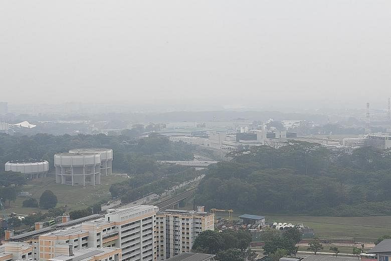 Haze in Woodlands and Kranji at 4.15pm yesterday. The air quality is forecast to be in the moderate range today. ST PHOTO: KHALID BABA