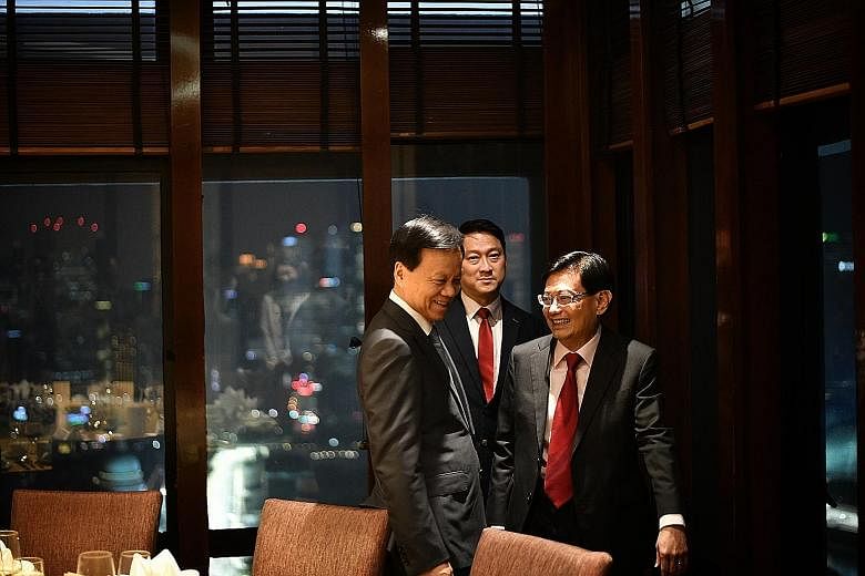 Chongqing party secretary and Chinese Communist Party Politburo member Chen Min'er (left) yesterday evening met Deputy Prime Minister Heng Swee Keat, who hosted him to dinner at the Peach Garden restaurant at OCBC Centre. Mr Chen, a rising political 