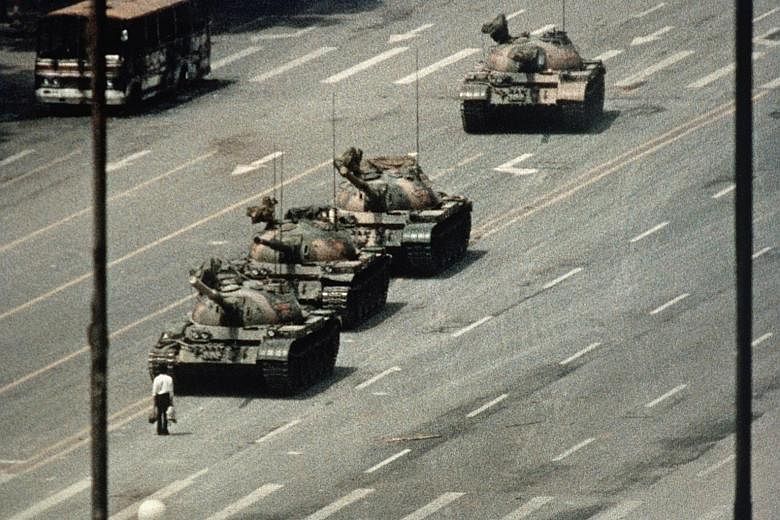 The iconic image of a lone unidentified man blocking a convoy of tanks during the Tiananmen Square protests in Beijing on June 5, 1989. American photojournalist Charlie Cole, who shot the image from the balcony of a hotel with a telephoto lens, has d