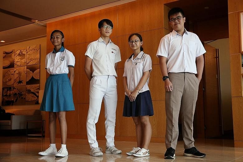 (From left) Nur Jannah Baizurah Abdullah, 12; Xu Jing Feng, 16; Tan Hui Xuan, 15; and Jacky Yeo, 18, are among the 30 beneficiaries of the school pocket money fund who received cash awards from Capital Group for doing well in their co-curricular activitie