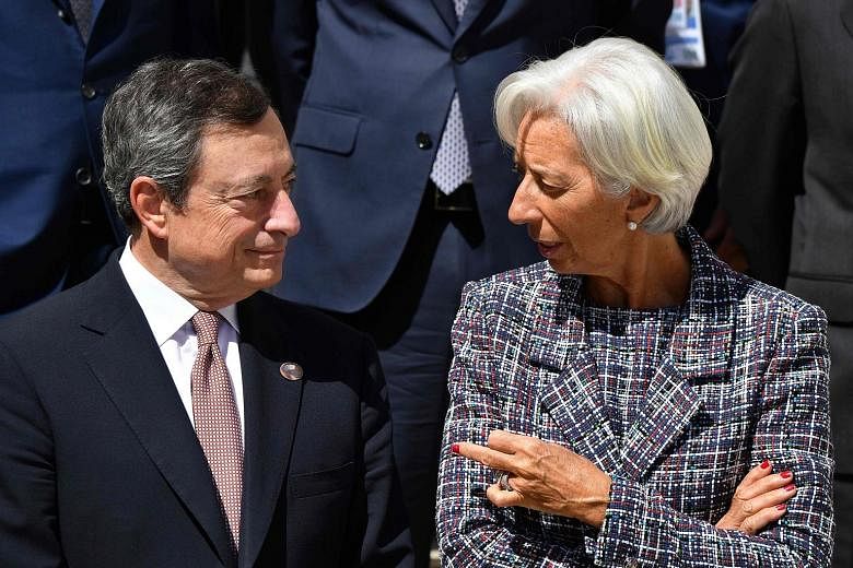 European Central Bank (ECB) president Mario Draghi with then International Monetary Fund managing director Christine Lagarde, in a May 2017 file photo. Ms Lagarde, who is succeeding Mr Draghi as ECB president, is preset to continue the policy of her 