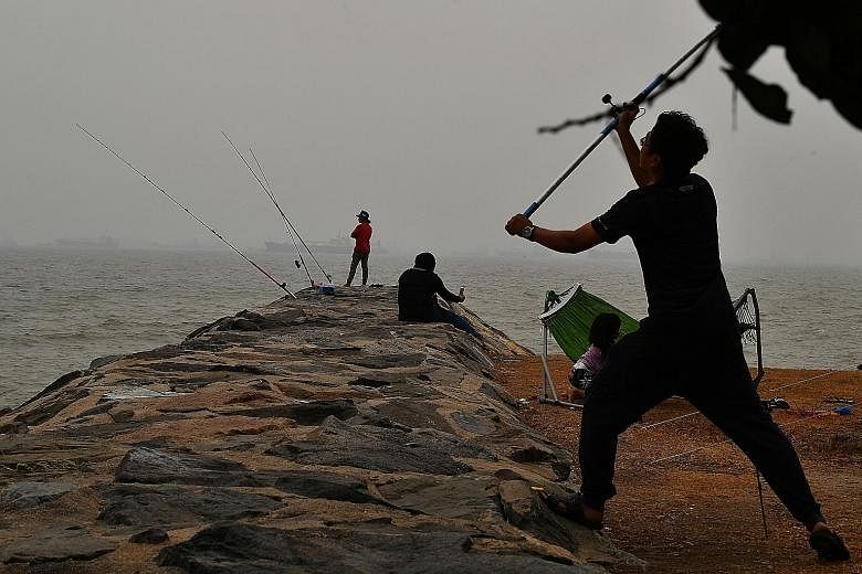 AYE AT JURONG AT 5PM YESTERDAY: A Pollutant Standards Index (PSI) reading of 106, within the unhealthy range, was reported in the west of Singapore. EAST COAST PARK AT 6.16PM YESTERDAY:People fishing at East Coast Park, when the 24-hour PSI reading i