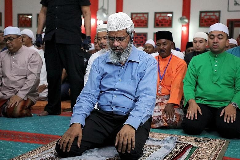Indian Islamic preacher Zakir Naik praying at a mosque in Melaka, Malaysia, on Sept 7. The writer argues that though Dr Zakir is allowed to remain in Malaysia as he has political value, it is time for the government to look after the interests of Mal