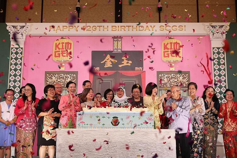 President Halimah Yacob (centre) celebrating Singapore Chinese Girls' School's 120th birthday last night, together with fellow SCGS alumni and other guests, including representatives of the SCGS board and staff. ST PHOTO: ONG WEE JIN