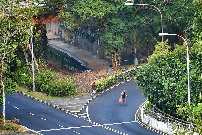 A man, suspected to be staying in the nearby forest at Chestnut Nature Park, washing his clothes using water from a monsoon drain. The men selling contraband cigarettes sprinting across a filter lane meant for vehicles exiting Bukit Timah Expressway 