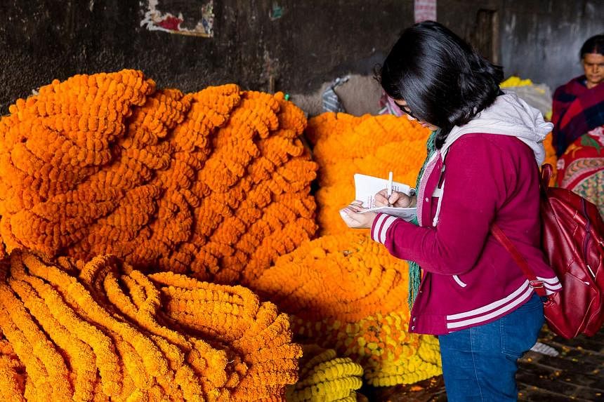 A participant of a walking tour takes in the sights at Kolkata’s Mallick Ghat flower market.