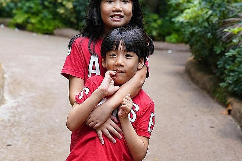 Charmeine Lee Kai En, 10, received an award for being an exemplary sibling to her brother, Bryan Lee Kai Jie, seven.
