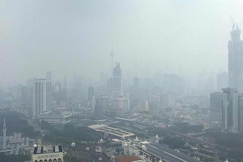 Kuala Lumpur shrouded in haze yesterday. Malaysia has lamented the lack of cooperation in solving the haze blanketing the region. PHOTO: ASSOCIATED PRESS