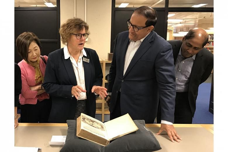 At the National Library of the Netherlands, Dr Marieke van Delft shows Minister for Communications and Information S. Iswaran the Itinerario, an account of the East Indies containing hand-coloured maps and illustrations by Jan H. van Linschoten. Also on t