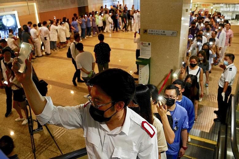 Medical workers protesting in the foyer of Prince of Wales Hospital in Hong Kong yesterday as the stand-off with the city's government continued. PHOTO: ASSOCIATED PRESS