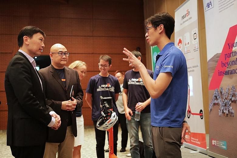 (From left) Senior Minister of State Chee Hong Tat and Mr Colin Lim, chief executive of mobilityX, speaking with Mr Joseph Ting, co-founder of car-sharing service Smove, at the official launch of Zipster at The Star Performing Arts Centre yesterday. 