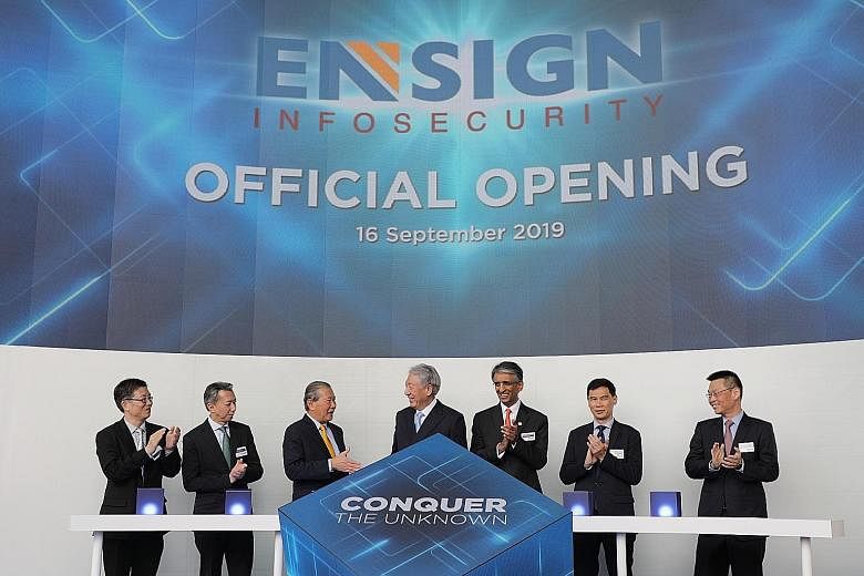 Senior Minister and Coordinating Minister for National Security Teo Chee Hean (centre) at the opening of Ensign InfoSecurity's global headquarters here yesterday with (from far left) Mr Teo Chin Hock, deputy chief executive of the Cyber Security Agen