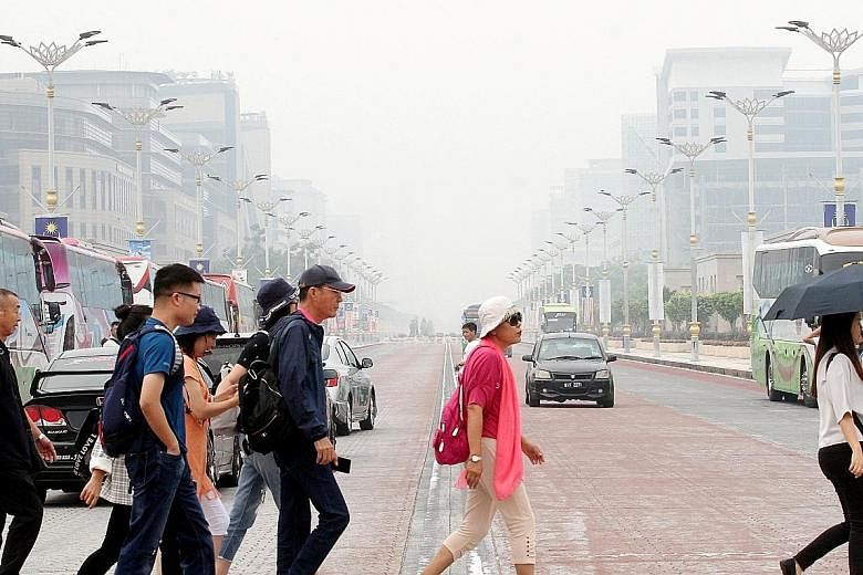 Hazy conditions in the administrative capital Putrajaya at around 11.30am yesterday. A total of 25 schools in the city are expected to shut today. PHOTO: THE STAR/ASIA NEWS NETWORK