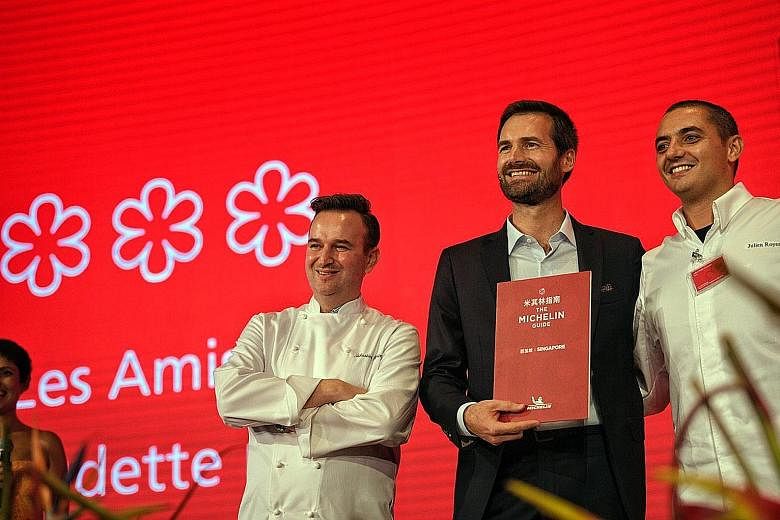 Chef Emmanuel Stroobant of Saint Pierre (far right) and chef Tristin Farmer of Zen, whose restaurants received two Michelin stars. Chef Sebastien Lepinoy (left) of Les Amis and chef-owner Julien Royer (right) of Odette with Mr Gwendal Poullennec, the