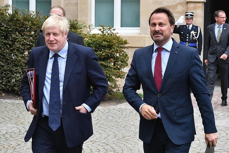 British Prime Minister Boris Johnson and Luxembourg Prime Minister Xavier Bettel leaving a Brexit meeting on Monday. Mr Johnson bowed out of a news conference with Mr Bettel on Monday amid intense public protests.