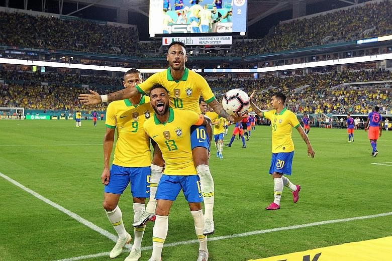 Brazil's Neymar (No. 10) celebrating with Dani Alves and teammates after scoring his side's second goal during the 2-2 friendly draw with Colombia at the Hard Rock Stadium, Florida, earlier this month. The flamboyant forward scored all four goals in 