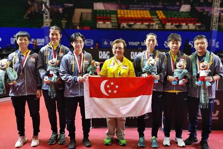 Singapore Table Tennis Association president Ellen Lee (centre) with the players and coach Hao Anlin (right) at the Asian championships. PHOTO: STTA