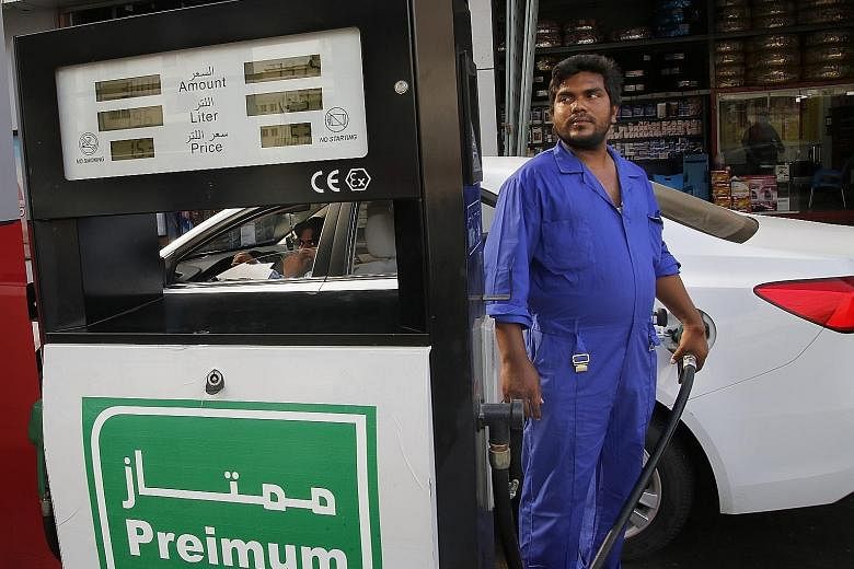 A car being refuelled at a petrol station in the Saudi Arabian port city of Jeddah yesterday. The weekend attacks on oil plants in Saudi Arabia sent crude prices soaring and raised fears of a new Middle East conflict. PHOTO: ASSOCIATED PRESS