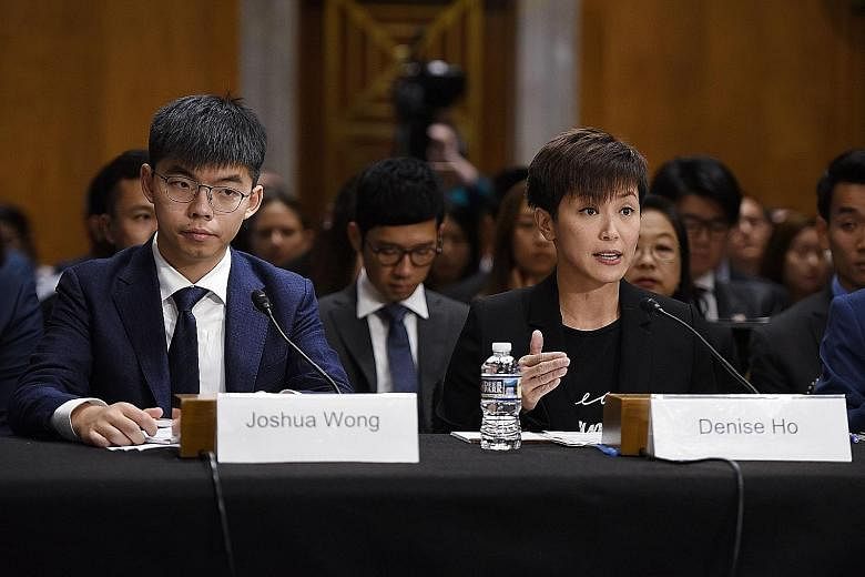 Hong Kong student leader Joshua Wong and singer-actress Denise Ho testifying before a bipartisan congressional commission about the pro-democracy movement in Hong Kong on Capitol Hill on Tuesday.