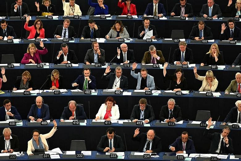European lawmakers voting during a plenary session following a debate on Brexit at the European Parliament in Strasbourg yesterday. They voted 544-126 with 38 abstentions for a resolution supporting another extension to the Brexit deadline.