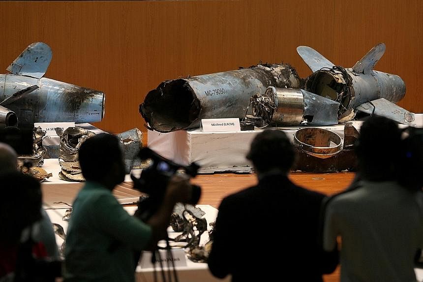 Remnants of missiles, which Saudi Arabia said were used to attack Aramco's oil facilities, on display during a news conference in Riyadh yesterday. Saudi Arabia said they were "undeniable" evidence of Iranian aggression. Teheran, however, again denie