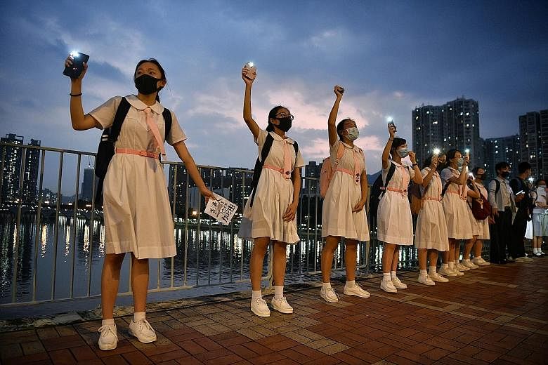 Pro-democracy students forming a human chain in a peaceful protest along the Shing Mun River in Hong Kong yesterday. ST PHOTO: CHONG JUN LIANG