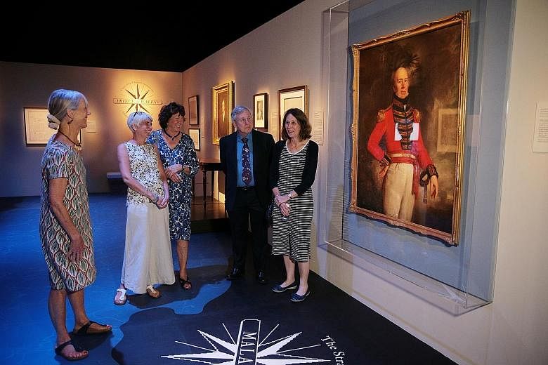 William Farquhar's descendants (above, from left) Ms Jane Ready, 71, Ms Morag Sutcliffe, 56, Ms Sally Richards, 74, Mr Anthony Lumsden, 71, and Ms Heather Lumsden, 67, before his portrait. They and the descendants of Stamford Raffles are in town for 