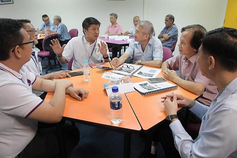 Labour chief Ng Chee Meng (centre) chatting with participants in a digital training class at the CityCab Building yesterday. The customised SkillsFuture for Digital Workplace one-day training programme started about three months ago, and a total of 1