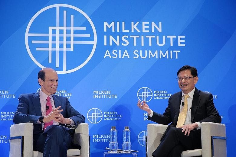 Deputy Prime Minister Heng Swee Keat at a dialogue at the Milken Institute Asia Summit which was moderated by the institute's chairman Michael Milken yesterday. Mr Heng said the Government is ready to do "what needs to be done at the right time" to s