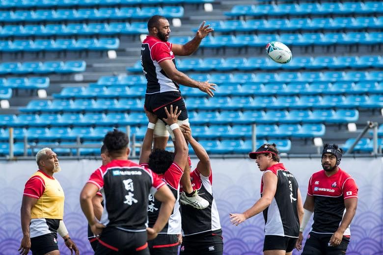 Japan flanker and captain Michael Leitch (top) training with his teammates at the Prince Chichibu Memorial Rugby Stadium in Tokyo ahead of the World Cup which begins today. PHOTO: AGENCE FRANCE-PRESSE