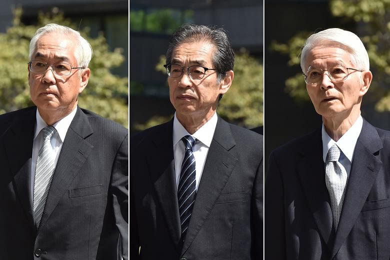 The three former top Tepco executives cleared by the court yesterday are (from left) Sakae Muto, Ichiro Takekuro and Tsunehisa Katsumata. PHOTOS: AGENCE FRANCE-PRESSE Activists rallying outside the Tokyo District Court yesterday as judgment was hande