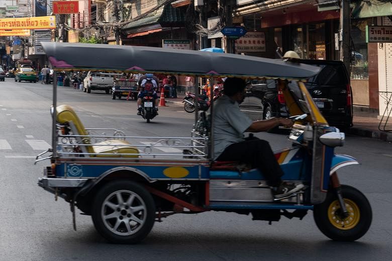 A prototype of the self-driving tuk-tuk (left) in the gated community where the months-long trial will run and the usual tuk-tuk zipping through a Bangkok street (right). The tuk-tuk was chosen as a test vehicle because it is, among other reasons, mo