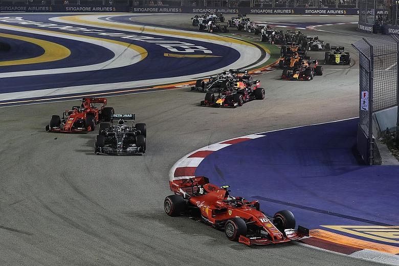 Ferrari’s Charles Leclerc, who started from pole position, leading the pack of drivers on the Marina Bay Street Circuit. 