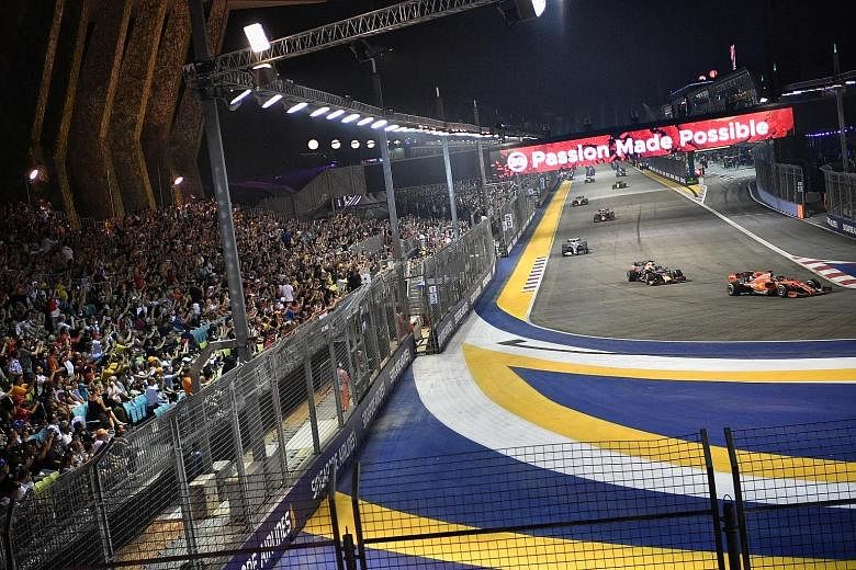 The crowd watching the action yesterday at the Singapore Airlines Singapore Grand Prix at the Marina Bay Street Circuit, which saw Sebastian Vettel thrilling fans with his victory. ST PHOTO: ARIFFIN JAMAR