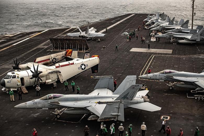Aircraft on the flight deck of the USS Abraham Lincoln, in the North Arabian Sea. The ship was preparing to launch an attack against Iran on June 20, but the final order never came. PHOTO: NYTIMES