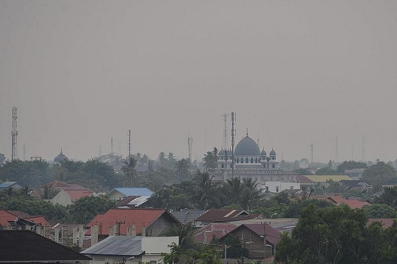 Hazy skies in Banda Aceh, capital of Aceh province, in Sumatra, yesterday. The Indonesian Environment and Forestry Ministry's law enforcement director-general Rasio Ridho Sani told The Straits Times that a few companies affiliated to Singapore and Ma