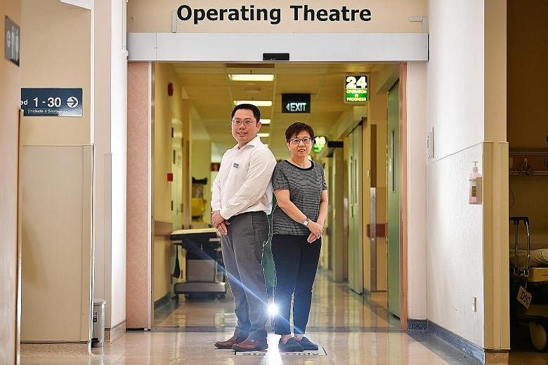 Ms Michelle Tan benefited from Tan Tock Seng Hospital's Enhanced Recovery After Surgery programme. She said she was able to get out of bed and walk, four hours after keyhole surgery to remove a tumour in her colon. She is seen here with Dr How Kwang 