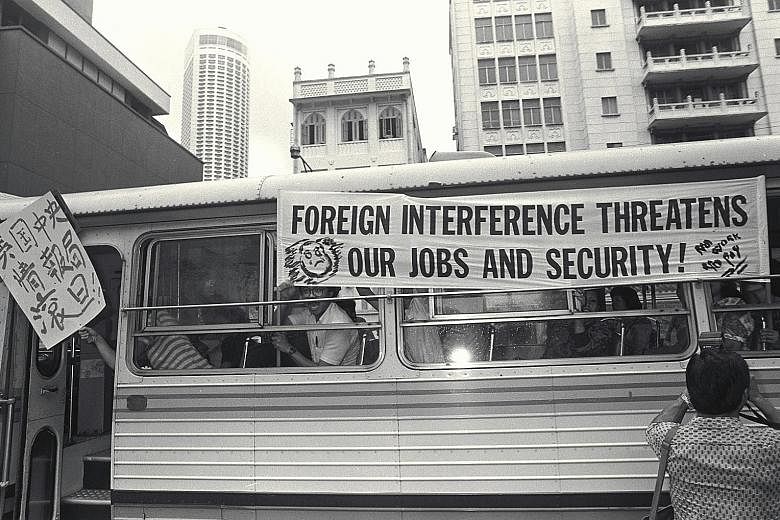 A 1988 file photo of workers who drove past the US Embassy in Hill Street in 18 buses which carried banners and placards telling the US to keep out of Singapore's affairs. A file photo of editorial staff at the Singapore Herald, which was shut down i