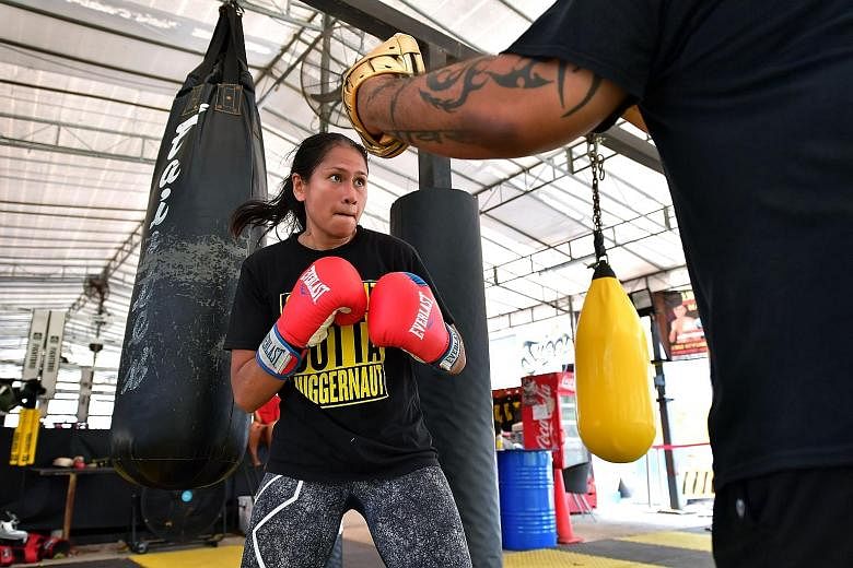 Local professional boxer Nurshahidah Roslie training for her WBC Silver bout on Saturday against China's Fan Yin. The sport is tough not only on her body but also burns a hole in her pocket - while she is a trailblazer for women boxers here, she has 
