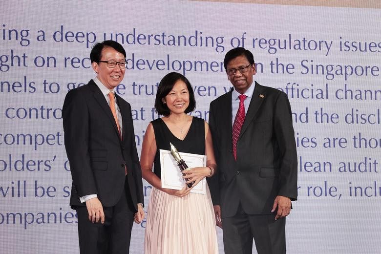 The Business Times' senior correspondent Angela Tan with Mr Ong Cheong Tee, deputy managing director of financial supervision at the Monetary Authority of Singapore, and Mr David Gerald, president and chief executive of the Securities Investors Assoc