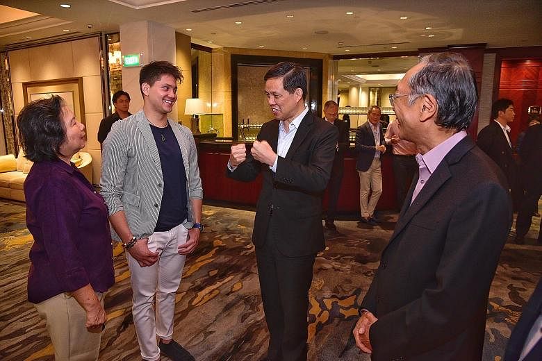 Minister for Trade and Industry Chan Chun Sing, the guest of honour at the Singapore Swimming Association's fund-raising dinner, speaking to Olympic gold medallist Joseph Schooling, his mother May and SSA president Lee Kok Choy. ST DESMOND WEE