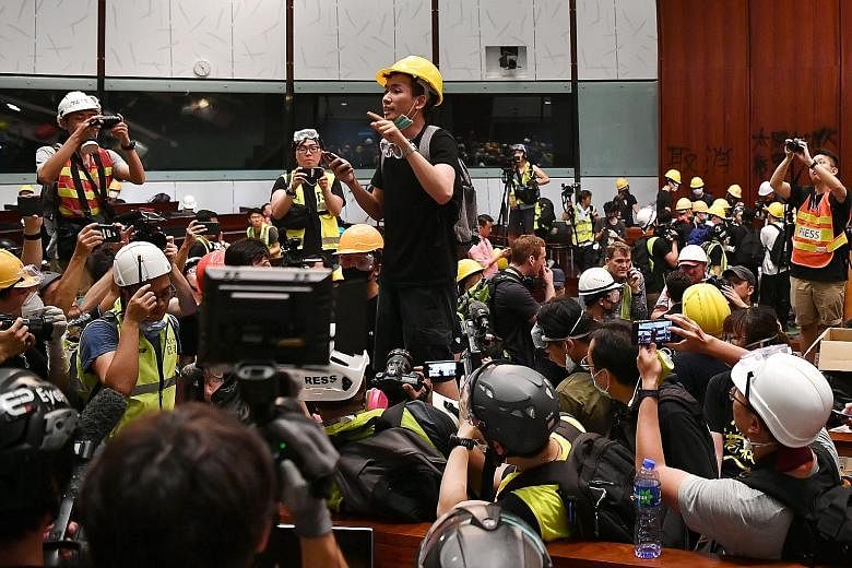 Mr Brian Leung Kai-ping, 25, openly revealed his identity, despite fellow protesters warning him against removing his mask, as he felt it was the defining moment of the night. PHOTO: LIM YAOHUI/THE STRAITS TIMES, SINGAPORE
