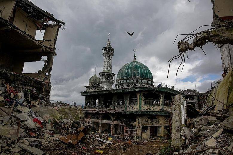 A mosque standing amid the ruins of the main battle area of Marawi City on Oct 25, 2017, after five months of intense fighting between Philippine government troops and ISIS-influenced fighters.
