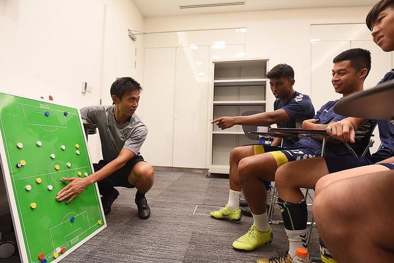Tampines Rovers coach Gavin Lee discussing tactics with his players earlier this season. Even though the Stags cannot finish higher than second, he is still pleased with their progress from last season's fourth place. 