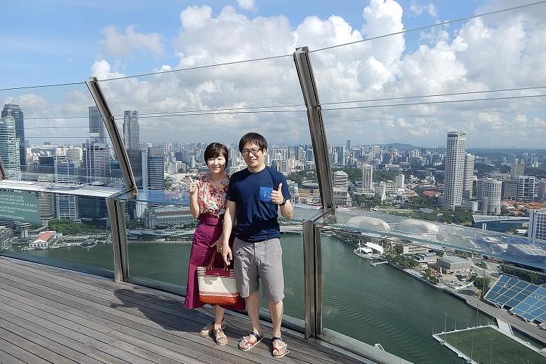 Japanese marketing director Rie Tokue and her husband posing on the Sands SkyPark Observation Deck during their visit to Singapore in May.