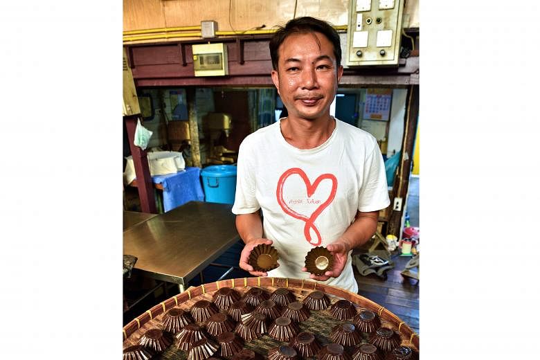 Thanusingha Bakery House's owner Teepakorn Sudjidjune (left) with the moulds used to make its popular egg cakes (above), a hard-to-find treat in Bangkok. The Santa Cruz Catholic Church (above) is one of the oldest structures the Portuguese built in t