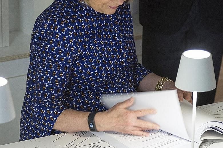 Mrs Hillary Clinton at US artist Kenneth Goldsmith's art exhibition dedicated to her e-mails in Italy this month. Her use of a private e-mail server during her term as secretary of state triggered multiple probes.