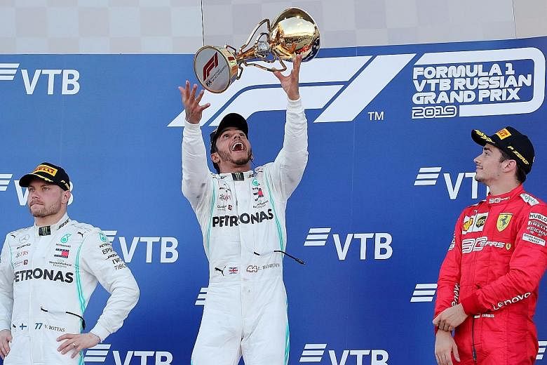 Lewis Hamilton tossing his winner's trophy on the podium, alongside Mercedes teammate Valtteri Bottas and third-placed Charles Leclerc, whose Ferrari team had won the last three races - prompting Hamilton to say that it felt like a long time since he last