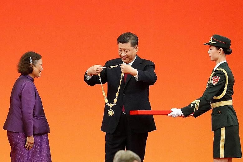 Chinese President Xi Jinping awarding the Friendship Medal to Thai Princess Maha Chakri Sirindhorn at the Great Hall of the People in Beijing yesterday. Mr Xi awarded medals and honorary titles to an array of domestic and international "heroes", ahea